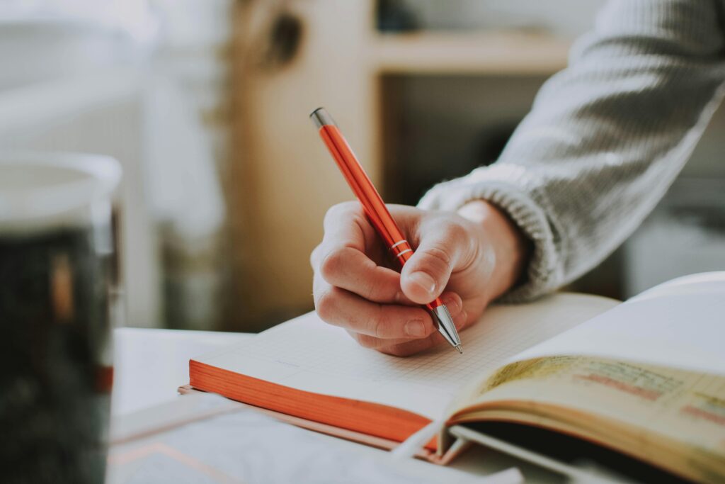 Student writing on book